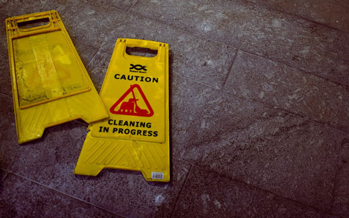 Cleaning sign fallen on a dark floor Trip Hazard Small